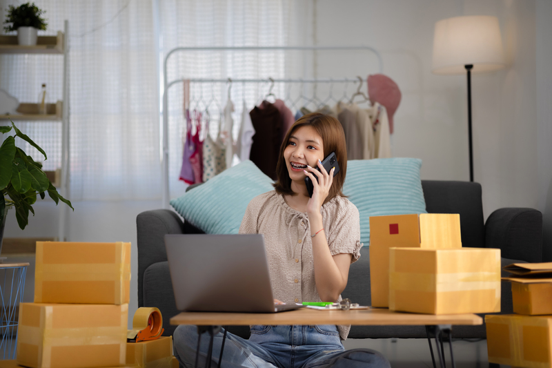 Smiling happy young woman entrepreneur receiving phone call  for new sales order - How to track web user on ecommerce sites